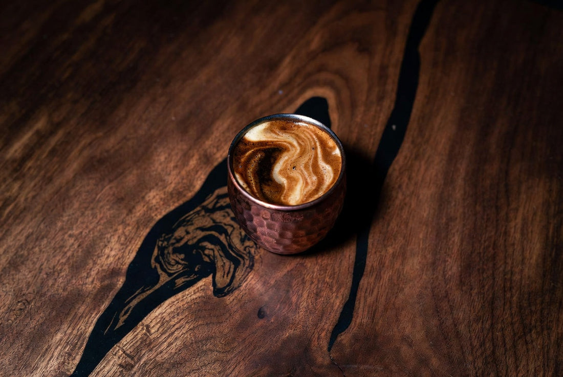 espresso shot glass on walnut table