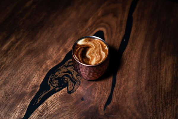 espresso shot glass on walnut table