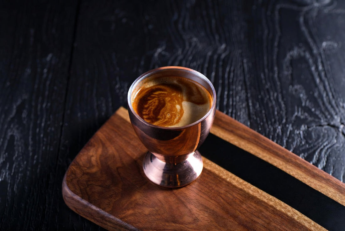 well extracted espresso shot top down view, copper shot glass