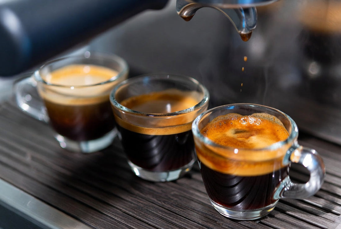 A photo image of three espresso cups with varying roast levels on a wooden surface.