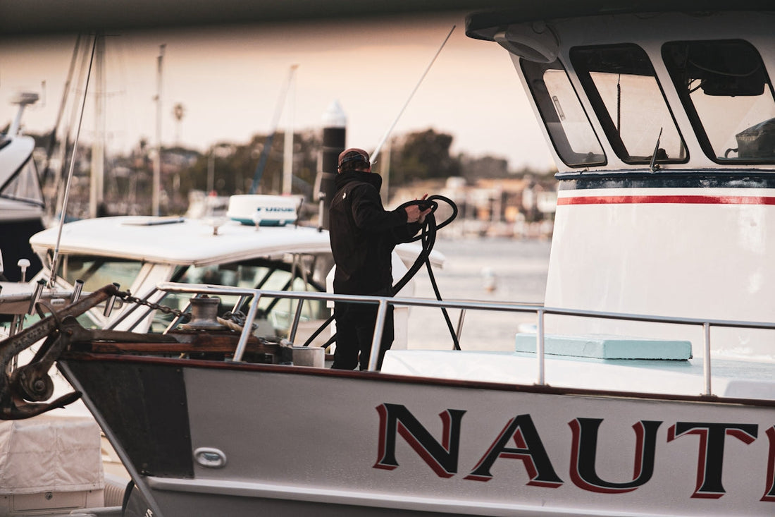 man on yacht in pier