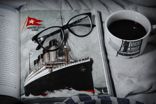 black framed eyeglasses on white and black boat print textile