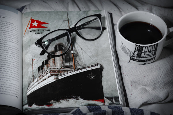 black framed eyeglasses on white and black boat print textile
