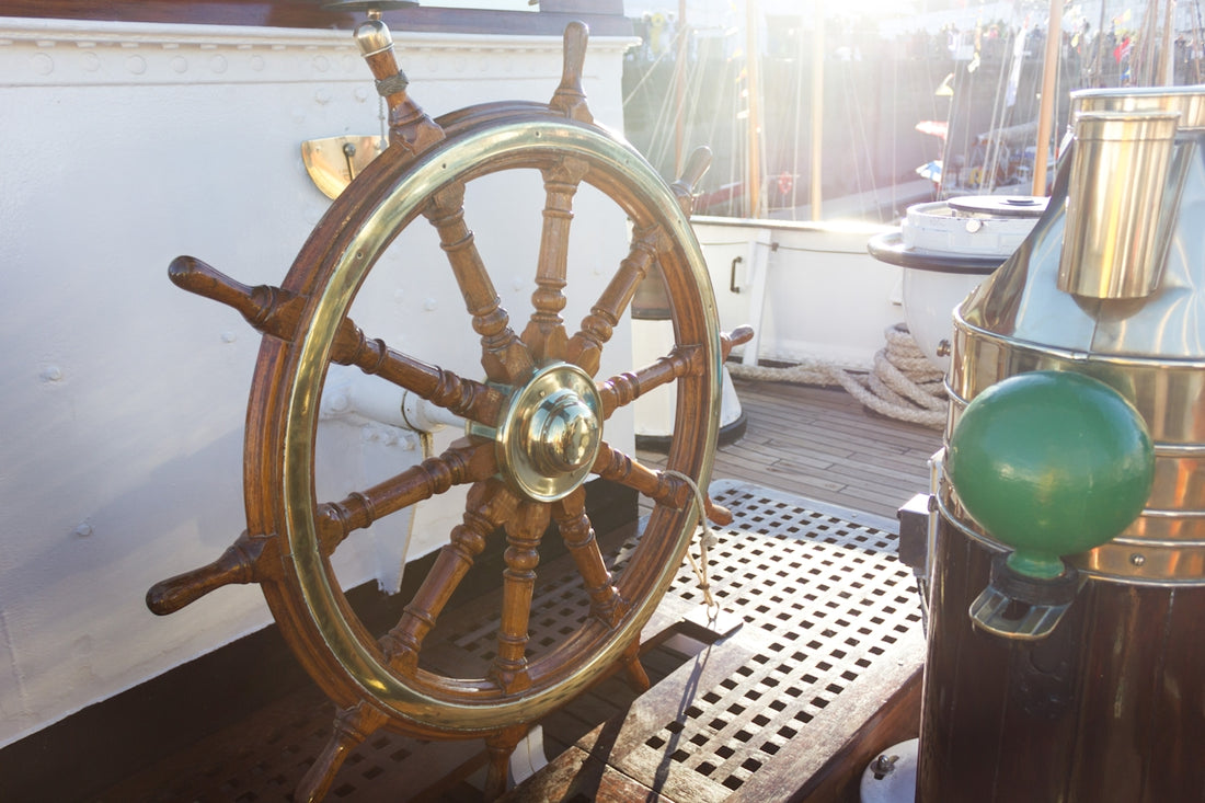 a ship's steering wheel on the deck of a ship