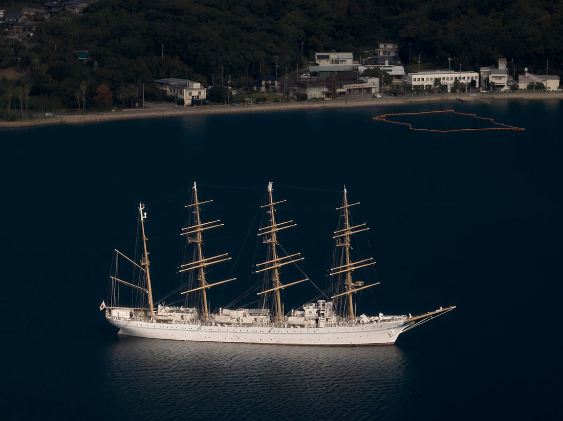 A large white boat floating on top of a body of water