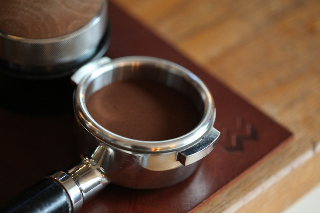 Espresso portafilter filled with ground coffee