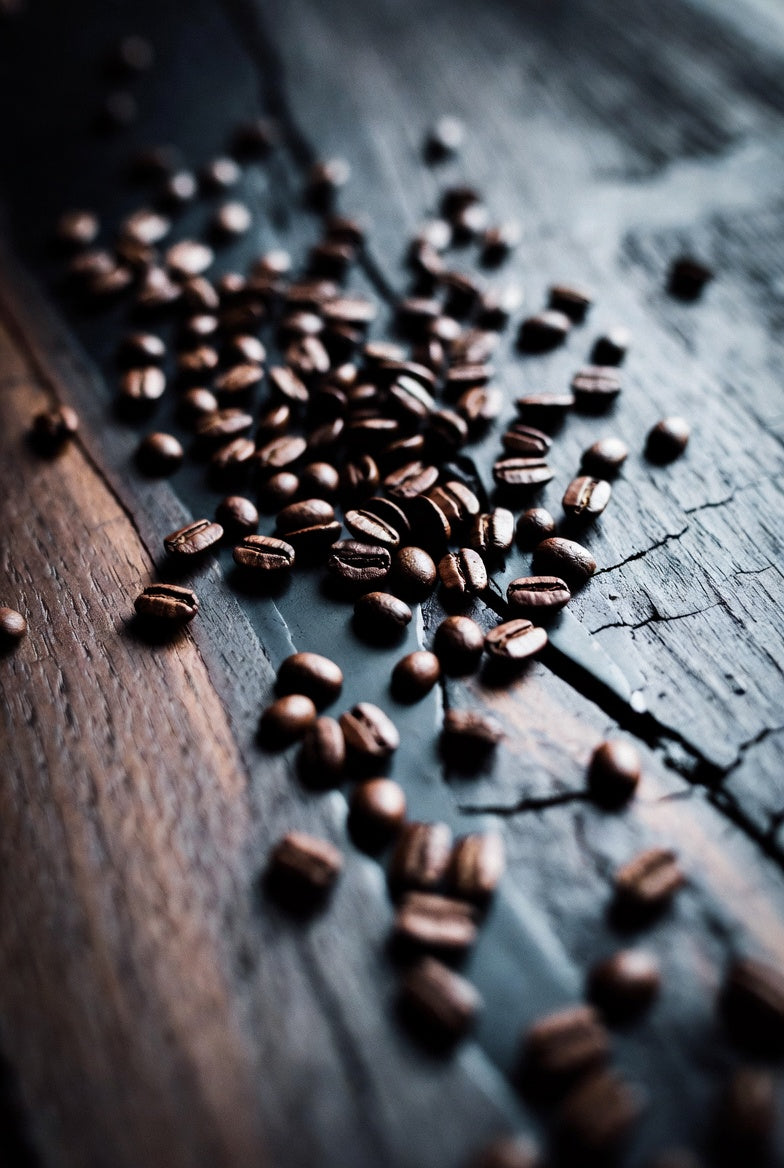 Coffee beans scattered on a wooden surface