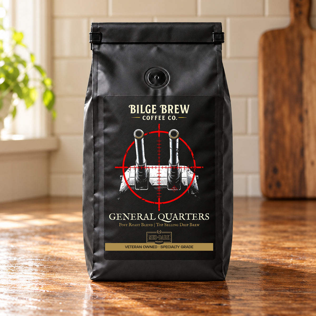A black coffee bag from Bilge Brew Coffee Co. standing on a wooden table in a kitchen setting.