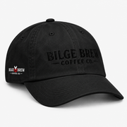 A black washed cotton baseball cap with the phrase 'Bilge Brew Coffee Co' embroidered in white on the front, shown against a white background.