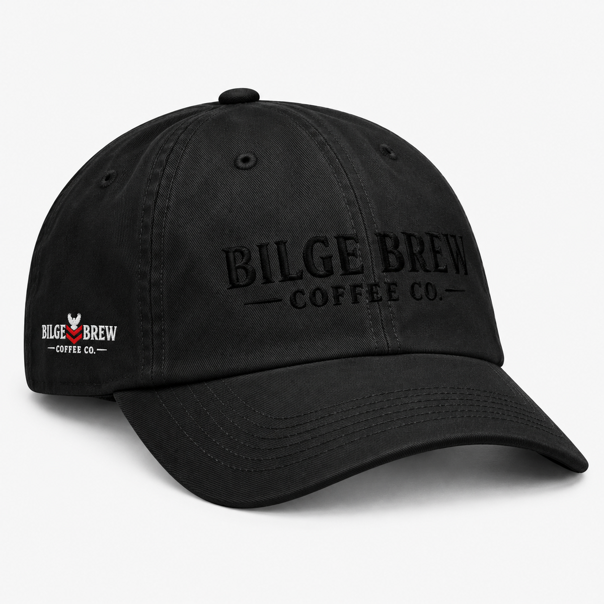 A black washed cotton baseball cap with the phrase 'Bilge Brew Coffee Co' embroidered in white on the front, shown against a white background.