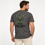 A man wearing a dark gray t-shirt with a large green and black dragon graphic and 'BILGE BREW COFFEE CO.' text on the back, shown from a three-quarters view against a light gray background.