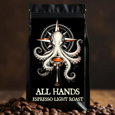 Coffee bag with an octopus design and 'All Hands Espresso Light Roast' text, surrounded by coffee beans.