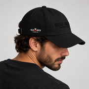 A man in profile wearing a black baseball cap with 'Bilge Brew Coffee Co.' embroidered on the side and front, photographed against a light gray studio background.