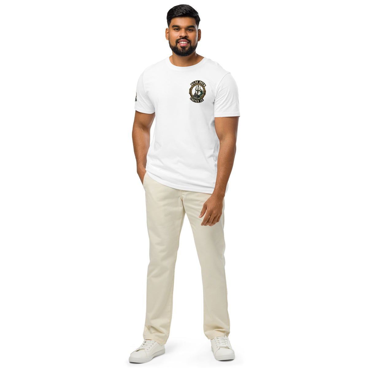 Man wearing a white t-shirt with a logo and beige pants on a white background