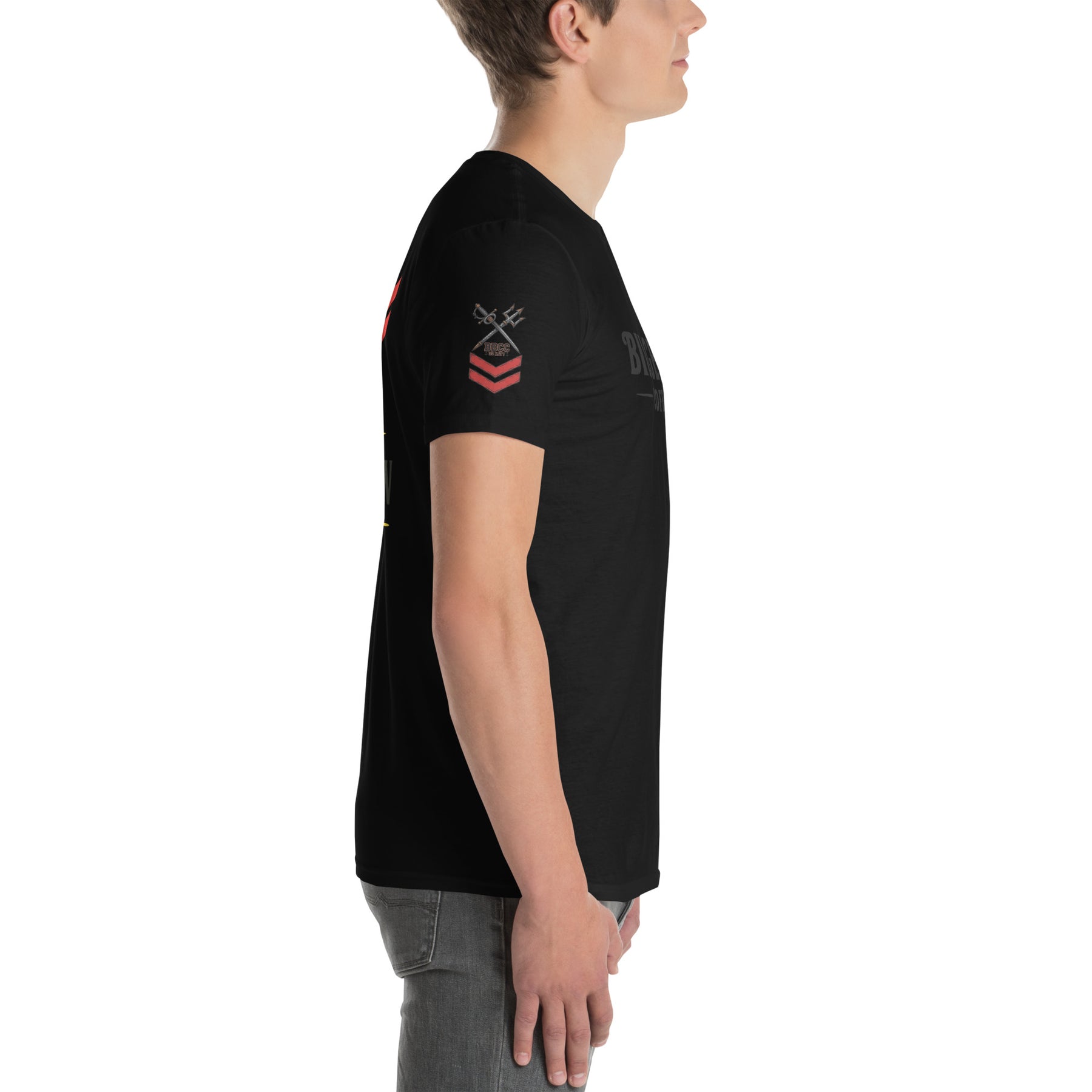 Person wearing a black t-shirt with a small white logo on a white background