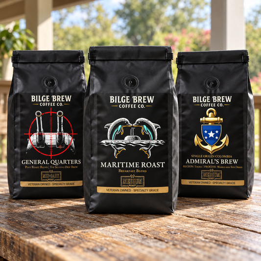THREE BILGE BREW COFFEE BAGS IN ON A WOOD TABLE OUTSIDE ON A PATIO