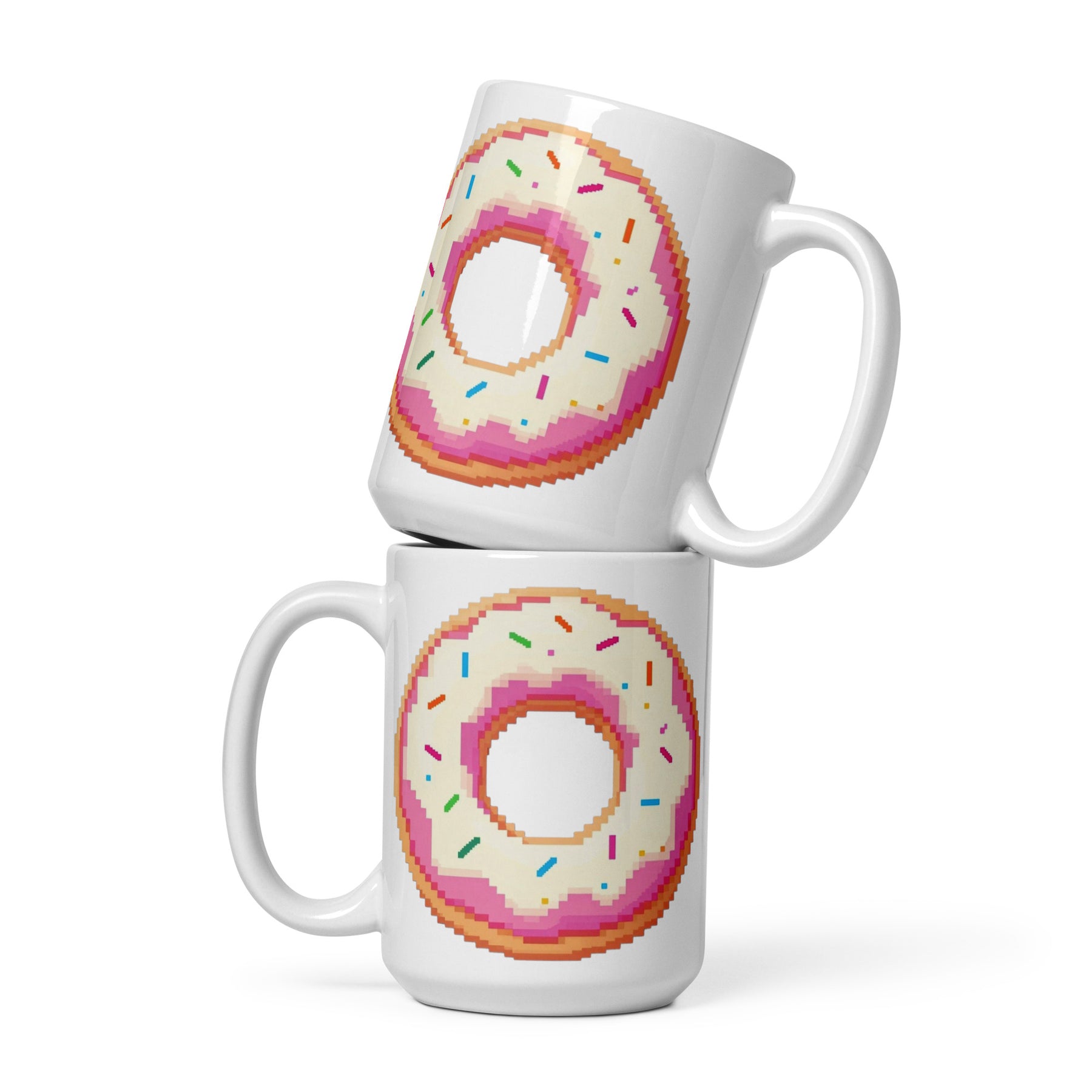Two stacked white ceramic mugs featuring a pixel-art style donut design with pink frosting, white icing, and multicolored sprinkles on a clean white background.