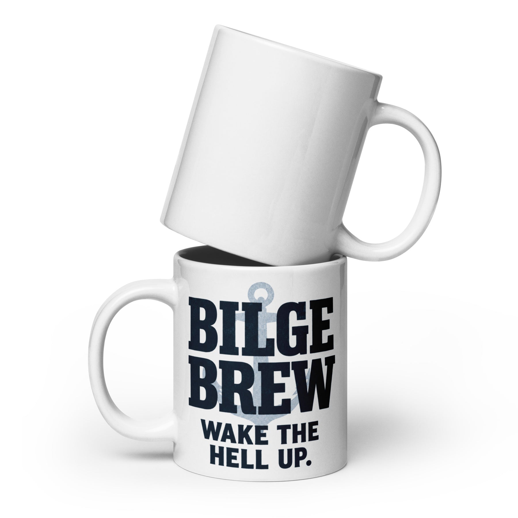 Two white ceramic mugs stacked on a white background. The bottom mug has bold dark navy text reading 'BILGE BREW' and smaller text 'WAKE THE HELL UP.