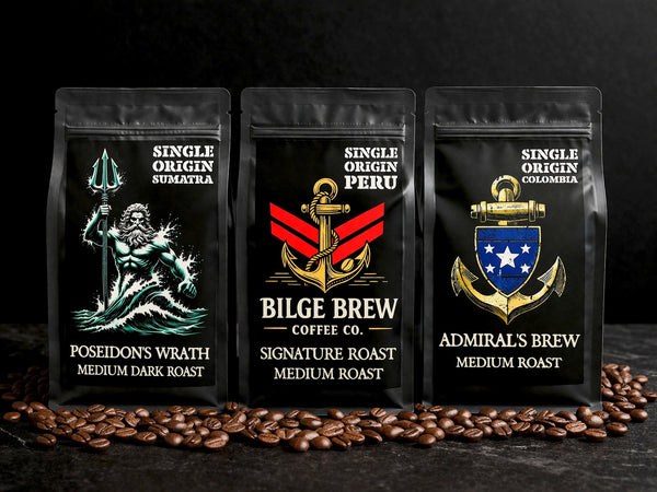 Three coffee bags from Bilge Brew Coffee Co. with coffee beans on a dark background