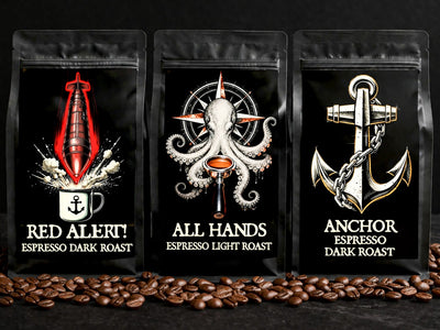 Three coffee packages with unique designs and roast labels on a black background with coffee beans.