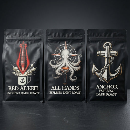 Three black coffee bags with maritime-themed designs and text on a dark background