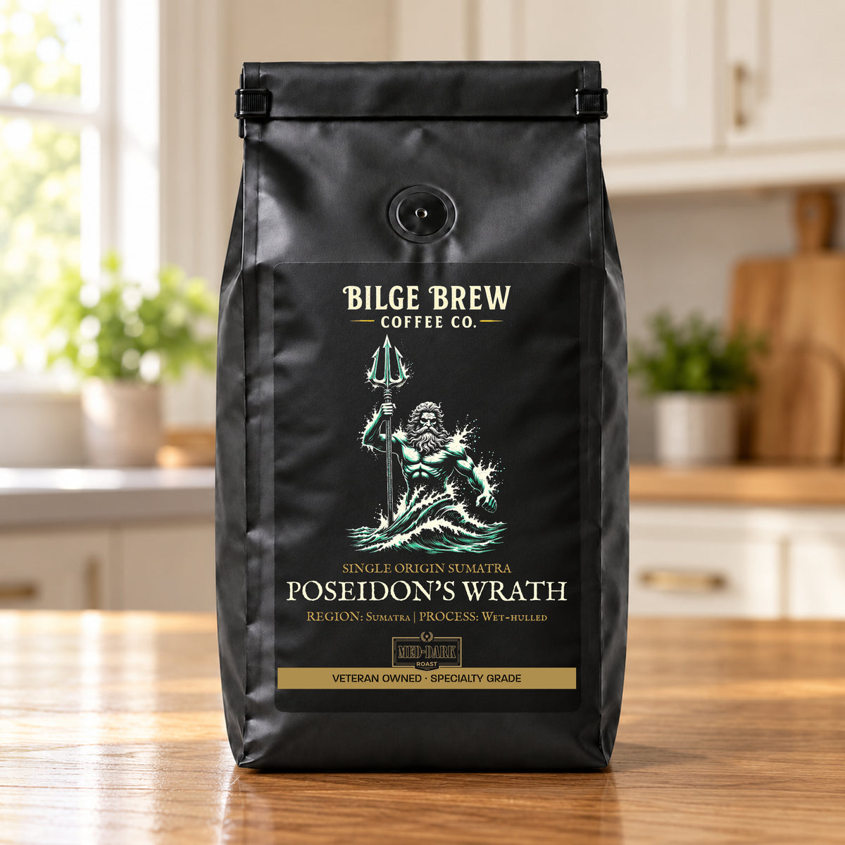 A black coffee bag from Bilge Brew Coffee Co. standing on a wooden table in a kitchen setting.