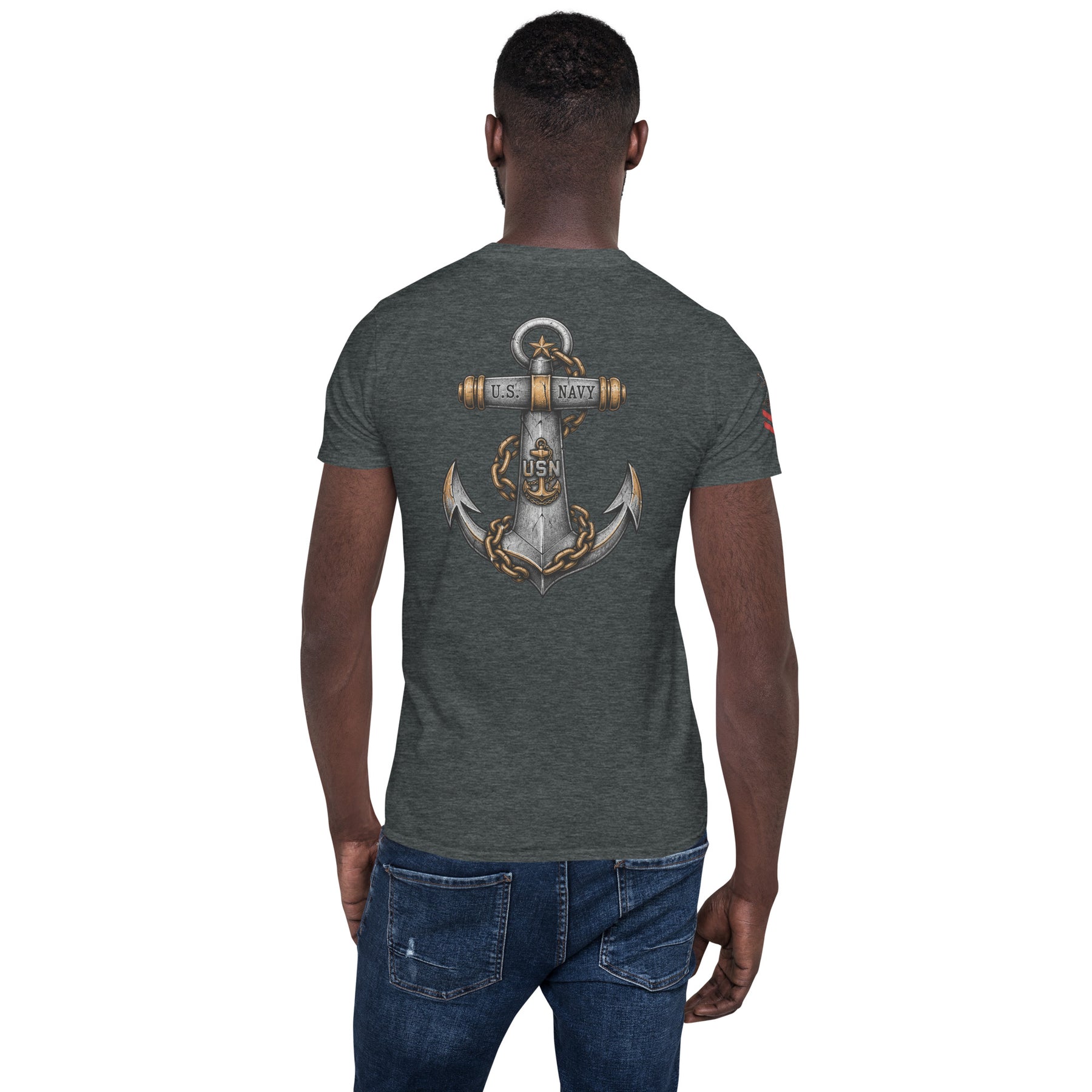 Person wearing a dark gray t-shirt with an anchor design on the back, standing against a white background.