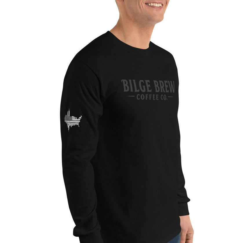 Person wearing a black long-sleeve shirt with logos on a white background