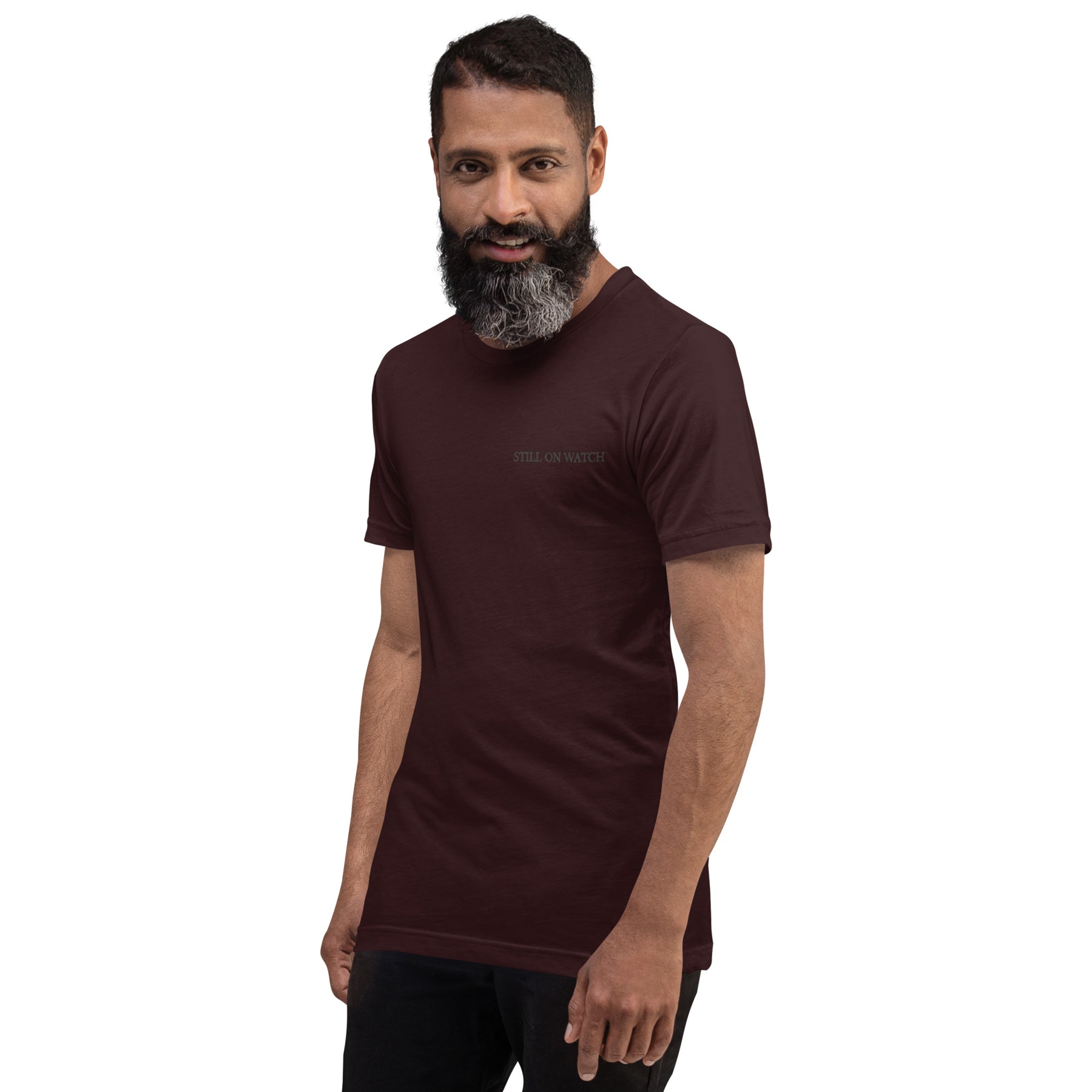 Man wearing a dark brown t-shirt with red graphics on a white background
