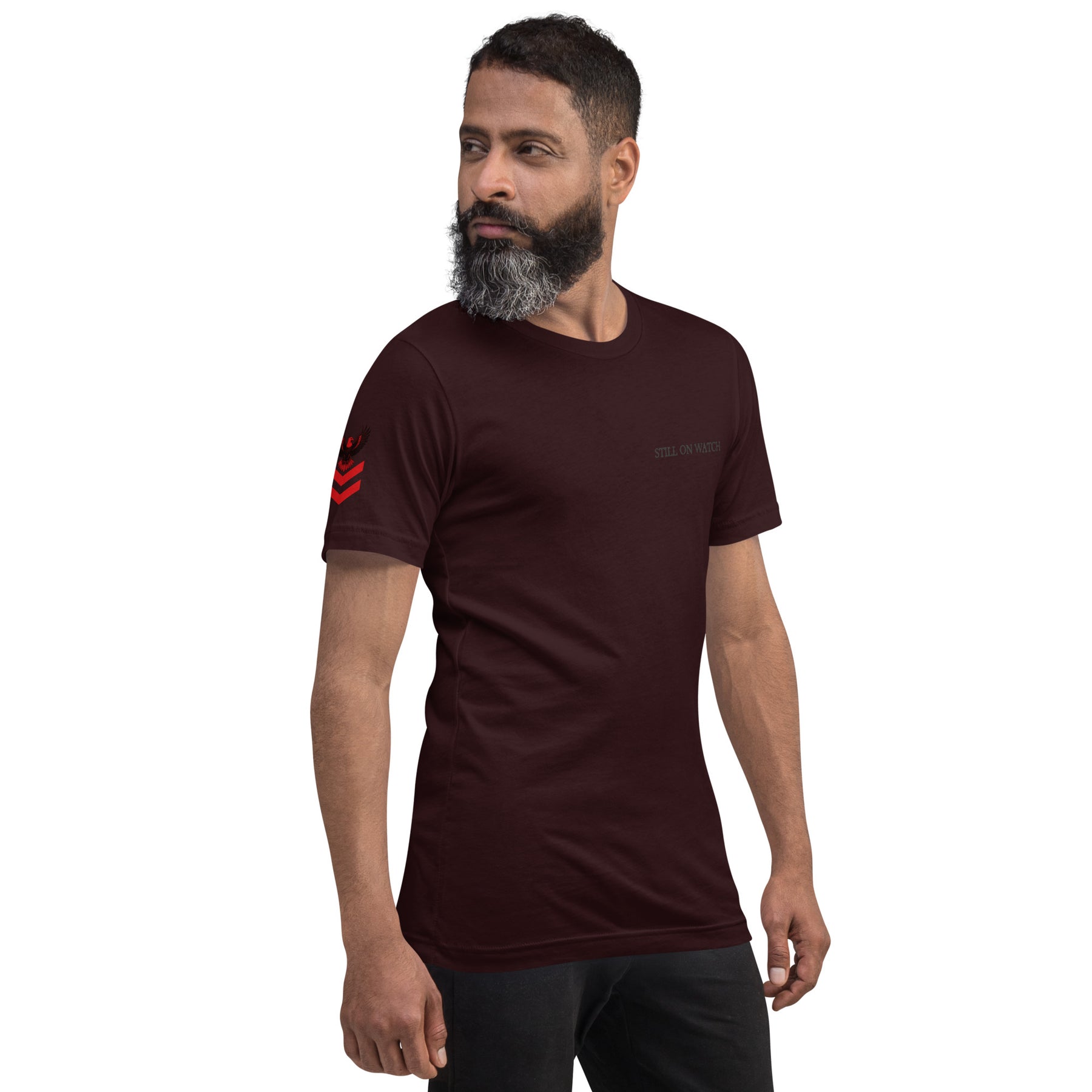Man wearing a dark brown t-shirt with red graphics on a white background