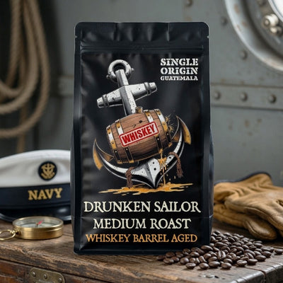 Coffee package labeled 'Drunken Sailor' with a whiskey barrel design on a wooden surface.